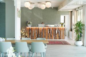 an office lobby with a desk and chairs at Junior Family Hotel in Cavallino-Treporti