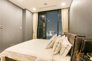 a bedroom with a bed with a large window at Jessie Apartment - Infinity pool - Rivergate Residence in Ho Chi Minh City