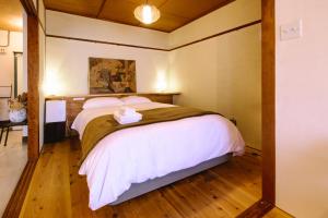 a bedroom with a large bed in a room at Guesthouse RICO in Wakayama +74 photos