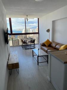 salon z kanapą i stołem w obiekcie GEMELOS 15 TURIS - PREMIUM Apartamentos w mieście Benidorm