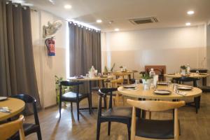 a dining room with wooden tables and chairs at Mavens Orange in Gurgaon