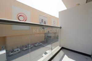 a view of a building with cars in a parking lot at KeyHost - Crystal Residence JVC - K160 in Dubai