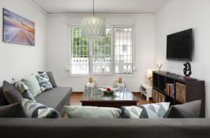 a living room with a couch and a table at Apartment Los Olivos Heated Pool in Rincón de la Victoria