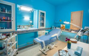 a blue hospital room with a bed in it at Seabel Aladin Djerba in Aghīr