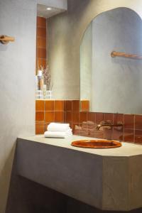 a bathroom with a sink and a mirror at Hotel Orphée - Orso Hotels in Paris