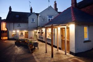 a house with a pavilion in front of it at Alfred Russel Wallace Restaurant with Rooms in Usk