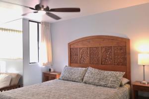 a bedroom with a bed and a ceiling fan at Kealia Resort 203 in Kihei