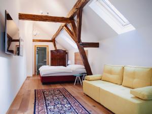 ein Wohnzimmer mit einem Sofa und einem Bett in der Unterkunft Georgi Schloss - Boutique Hotel in Ehrenhausen