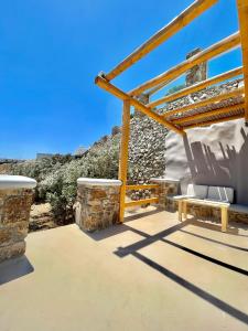 a patio with a bench and views of the ocean at Crystal Suites in Mýkonos City