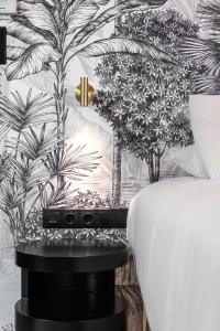 a bedroom with a black and white mural of palm trees at Athens Feeling in Athens