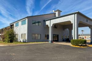 a large white building with an open garage at Econo Lodge Inn & Suites Sweetwater I-20 in Sweetwater