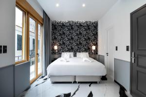 a bedroom with a white bed and a black wall at Athens Feeling in Athens