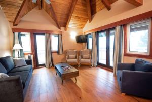 a living room with a couch and a table at Painter's Lodge, Trademark Collection by Wyndham in Campbell River