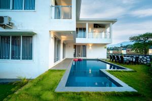 a house with a swimming pool in the yard at Spicy Mango Villa Gardena - Luxurious Villa In Karjat in Thākurvādi