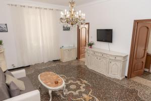 a living room with a couch and a tv at Living Sestri Airport in Genova