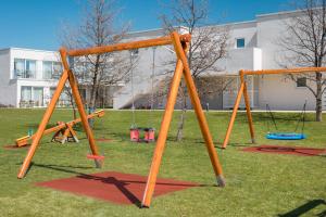 a group of swings in a park at Maj Luxury Residence in Poreč