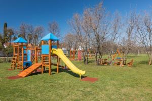 a playground with a slide in a park at Maj Luxury Residence in Poreč