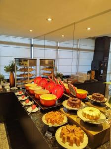 a buffet with many plates of food on a counter at Hotel Reymar Express in Maceió