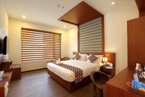 a bedroom with a large bed and a window at Eloor Tourist Home in Ernakulam