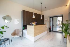 a lobby with a reception desk and a chair at Ah Villaglori Boutique Apartments in Brescia
