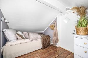 a bedroom with a bed in a attic at Luxurious Boathouse with Private Dock in the Best Location in Arendal in Arendal