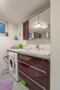 a kitchen with a sink and a washing machine at Ferienhaus Karoline in Lichtpold