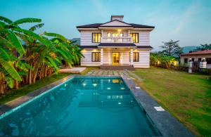 a house with a swimming pool in front of a house at Spicy Mango Villa Insam - Hill View Villa In Karjat in Karjat