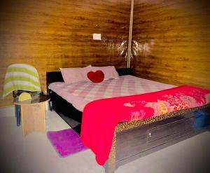 a bedroom with a bed with a red heart on it at OYO Mayur Guest House in Jīnd