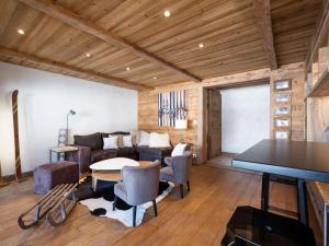 a living room with a couch and a table at Appartement La Clusaz, 4 pièces, 7 personnes - FR-1-304-232 in La Clusaz