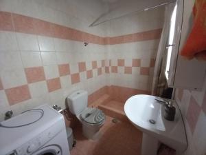 a small bathroom with a toilet and a sink at Tripoli Center in Tripolis