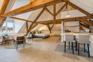 a kitchen and living room with wooden beams at Obelisque in Bruges