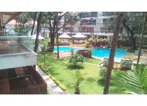 a view of a pool from the balcony of a hotel at Aarju Luxurious Stay Calangute in Calangute