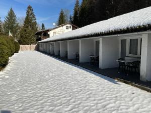 a white building with snow on the ground at Hotel Schachten in Lindberg