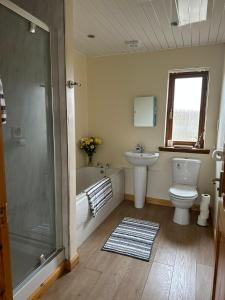 a bathroom with a toilet and a sink and a shower at Deleted in Airdrie