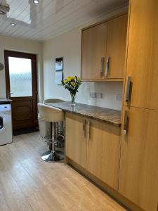 a kitchen with a counter with a vase of flowers on it at Deleted in Airdrie