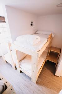 a bedroom with a bunk bed in a room at Latas Surf House in Somo