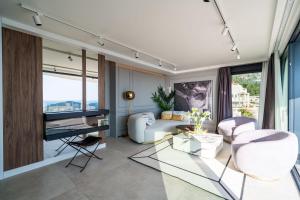 a living room with a couch and a television at Lux Kalifa 5 Star Exquisite Residence in Dubrovnik