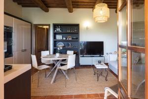 a kitchen and dining room with a table and chairs at Toscana Amore Mio, stunning view & 14min Volterra in Montecatini Val di Cecina