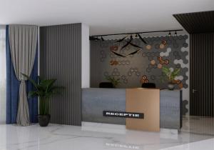 an office with a reception desk with a sign on the wall at HOTEL TOPAZ 4* CAP AURORA in Cap Aurora