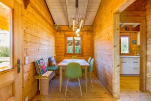 una sala da pranzo in una baita di tronchi con tavolo e sedie di Ferienhaus Südeifel a Waxweiler