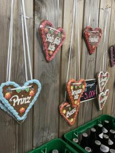 a bunch of hearts hanging on a wall at Wies'n Camp in Munich