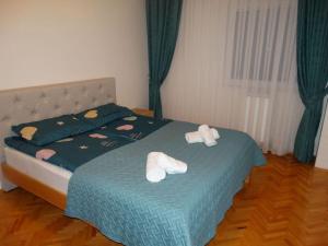 a bedroom with a bed with two towels on it at Miro's Place in Skopje
