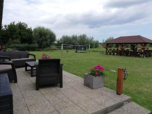 a patio with chairs and a soccer field with a soccer goal at Nad Krolewiecka in Sztutowo