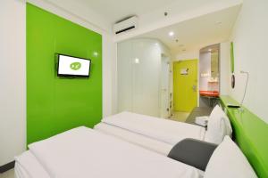 Postel nebo postele na pokoji v ubytování POP! Hotel Malioboro - Yogyakarta + 16 fotografií