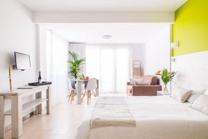 a white room with a bed and a desk at Dunas Club - Hotel & Apartamentos in Corralejo