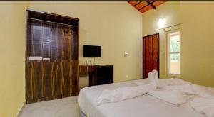Postel nebo postele na pokoji v ubytování Lazo Areca Resort , Coorg