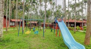 a playground with a slide in a park at Lazo Areca Resort , Coorg in Madikeri