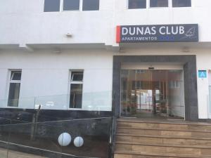a building with a dumas club sign on it at Dunas Club - Hotel & Apartamentos in Corralejo