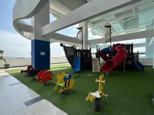 a play area with a playground with a slide at Melaka Duplex Penthouse 3 Bedroom The Wave Residence 9pax in Melaka