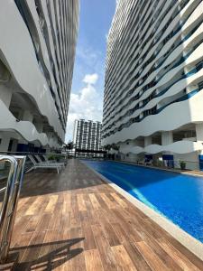 a swimming pool between two tall buildings at Melaka Duplex Penthouse 3 Bedroom The Wave Residence 9pax in Melaka